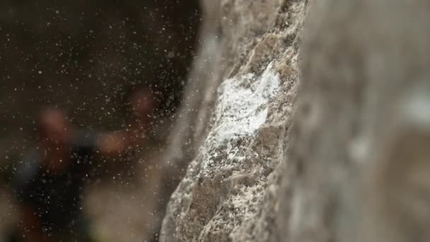 MACRO: Magnesium particles fly around a crimp hold after climber slips and falls — Stock Video