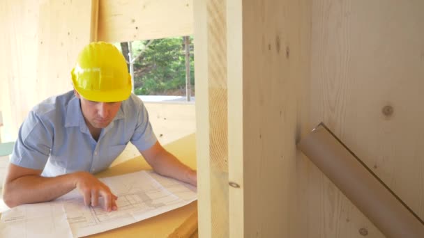 PORTRAIT: Young contractor smiles and gives thumbs up after analysing blueprints — Stock Video