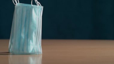 Parlak masaya düşen yepyeni cerrahi maskelerin sinematik görüntüleri..