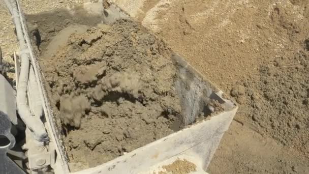 CERRAR: El mortero húmedo se mezcla dentro de una batidora grande en la parte posterior de una excavadora. — Vídeos de Stock