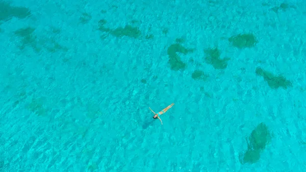 TOP DOWN: Female traveler enjoying her vacation in the glassy ocean water. — Stock Photo, Image