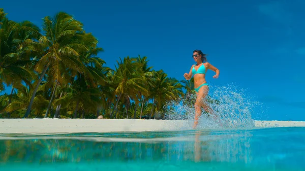 MAGYARORSZÁG: Boldog fitt lány bikini játékosan fut végig egzotikus homokos parton. — Stock Fotó