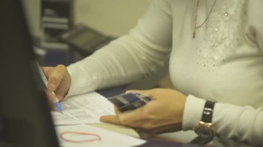 woman signs documents by hands