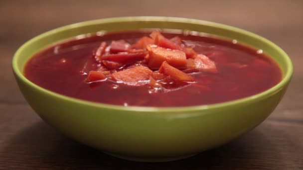 緑の皿の中のおいしい赤いボルシチ — ストック動画