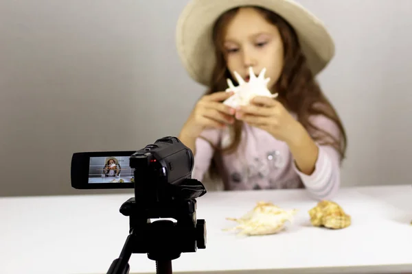 little girl is a blogger in front of the camera