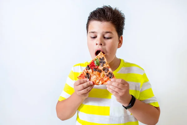 Мальчик ест пиццу. Счастливые детские обеды — стоковое фото