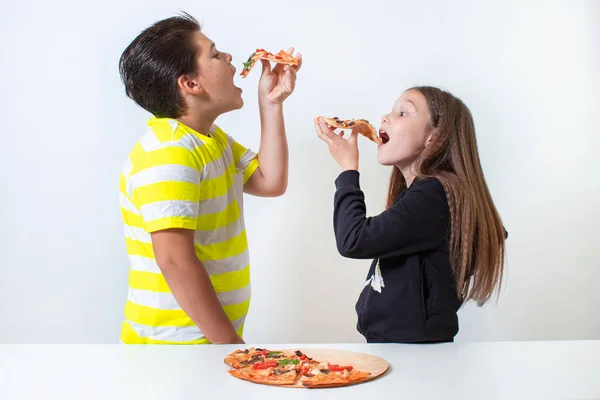 Niño y niña comiendo pizza. Los niños almorzan. —  Fotos de Stock