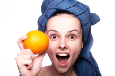 Kafasında havluyla portakallı güzel bir kız.