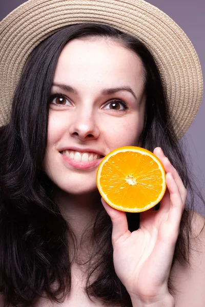 beautiful young girl with oranges, hat