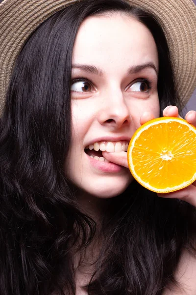 beautiful young girl with oranges, hat