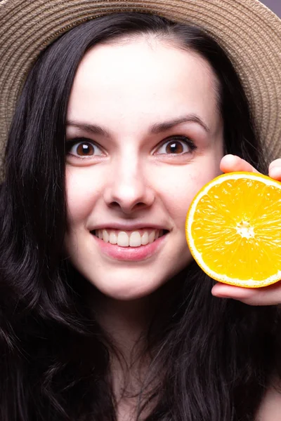 beautiful young girl with oranges, hat