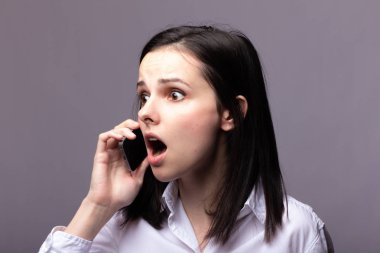 beyaz gömlekli kız telefonda iletişim kuruyor