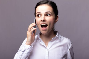 beyaz gömlekli kız telefonda iletişim kuruyor