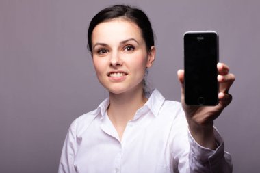 beyaz gömlekli kız telefonda iletişim kuruyor