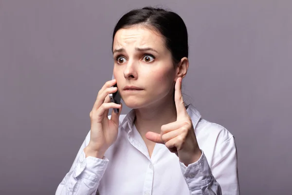 girl in a white shirt  communicates on the phone