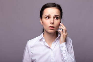 beyaz gömlekli kız telefonda iletişim kuruyor