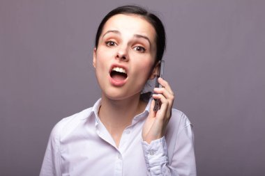 beyaz gömlekli kız telefonda iletişim kuruyor