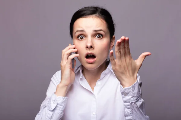 girl in a white shirt communicates on the phone