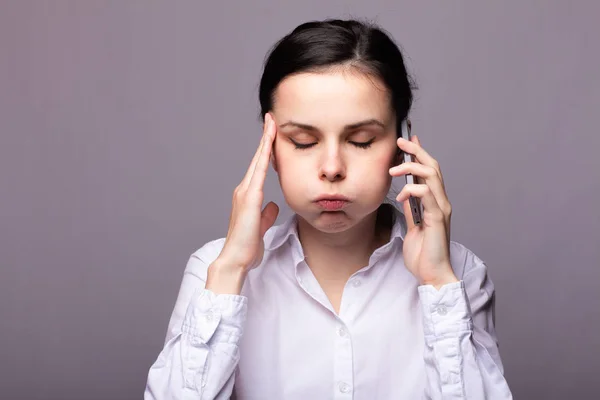 girl in a white shirt communicates on the phone