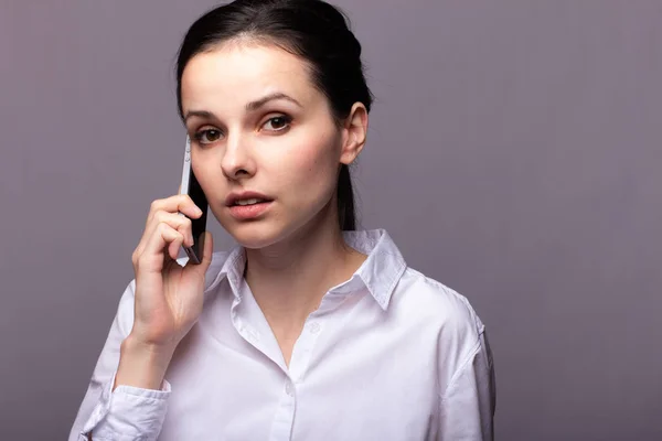 depositphotos 300078534 stock photo girl white shirt communicates phone испуганная девушка с телефоном