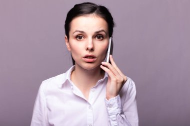 beyaz gömlekli kız telefonda iletişim kuruyor