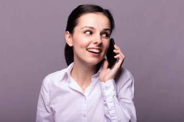 beyaz gömlekli kız telefonda iletişim kuruyor