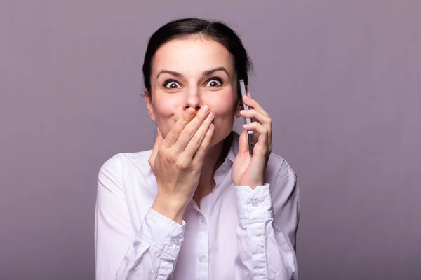 girl in a white shirt communicates on the phone