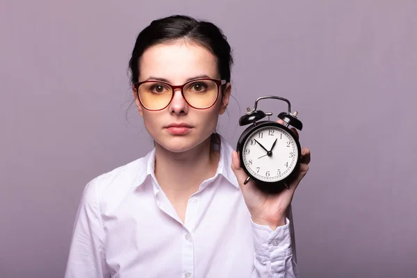 Girl White Shirt Glasses Holds Alarm Clock Her Hand — Stock Photo, Image