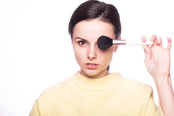 attractive girl does makeup, makeup brush