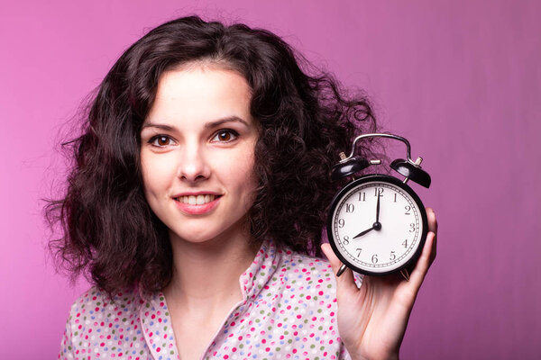  beautiful curly girl in pajamas, pink background