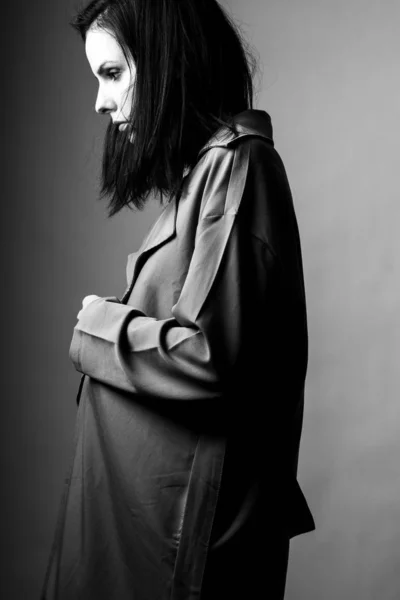 beautiful young girl in a trench coat, black and white