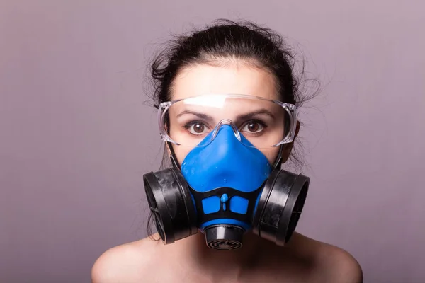 beautiful young girl in a respiratory mask