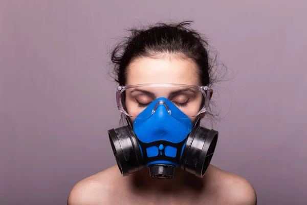beautiful young girl in a respiratory mask
