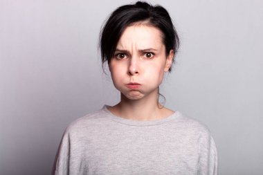 Gri arka planda güzel, anlamlı bir kadın, tek renk.