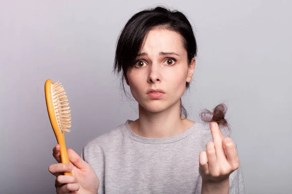 Emocionální Dívka Drží Hřeben Rukou Uzlíkem Vypadávání Vlasů — Stock fotografie