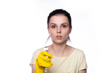 beautiful cleaning service woman in yellow cleaning gloves holds a fucking window cleaner in her hands