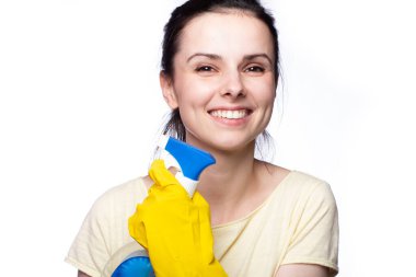 beautiful cleaning service woman in yellow cleaning gloves holds a fucking window cleaner in her hands