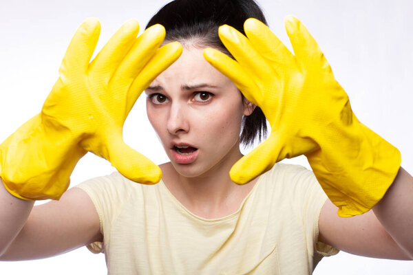 woman in yellow cleaning gloves, white background