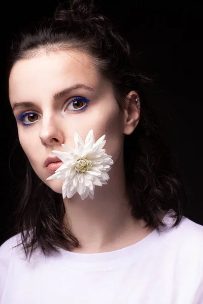 woman with a flower in her mouth, black background