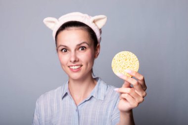 Süngerli, gri arkaplan, ped sorunu olan bir kadın...