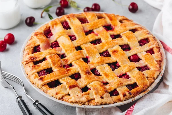 Homemade Cherry Pie with a Flaky Crust on Grey stone background.