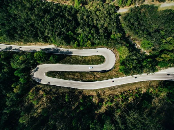 Aerial above view of a rural mountain landscape with a curvy road in Italy. Drone photography