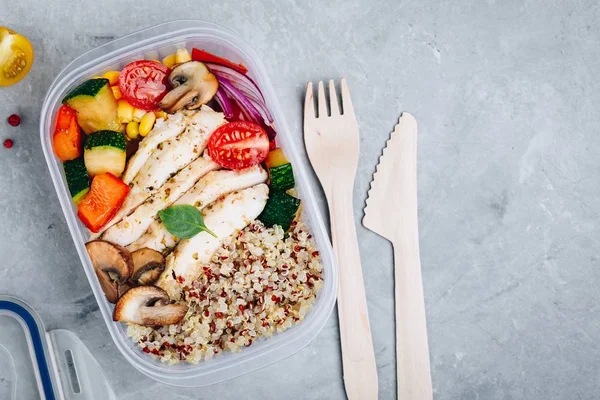 Meal prep lunch box containers with quinoa, grilled vegetables and chicken