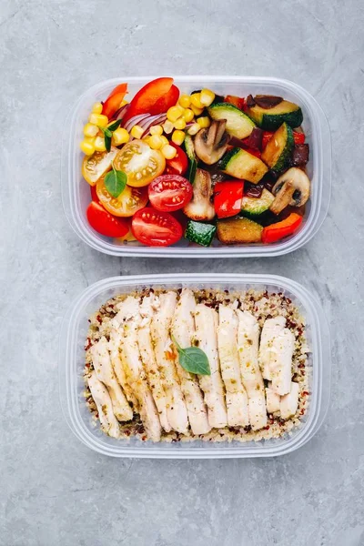 Meal prep lunch box containers with quinoa, grilled and fresh vegetables and chicken