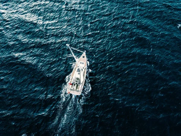 Aerial view of Sailing ship yachts with white sails  in deep blue sea