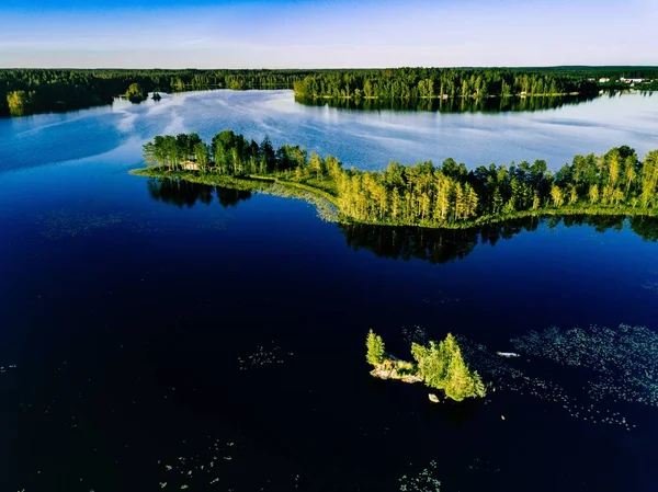 Luftaufnahme blauer Seen und grüner Wälder an einem sonnigen Sommertag im ländlichen Finnland. — Stockfoto