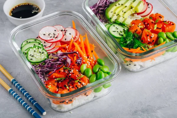 Poke meal prep containers with salmon, rice, radish, cucumber and avocado.