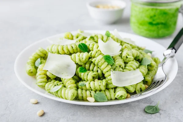 Fusilli pesto pasta with pine nuts, basil leaves and parmesan cheese — Stock Photo, Image