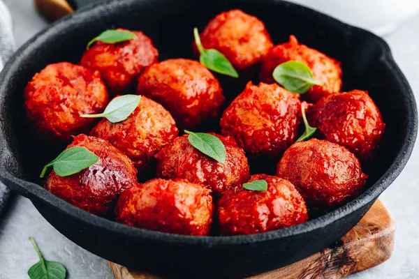 Homemade beef or chicken meatballs in tomato sauce in a frying pan — Stock Photo, Image