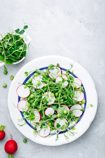 Fresh summer green pea shoots salad with radish. Вид сверху — стоковое фото